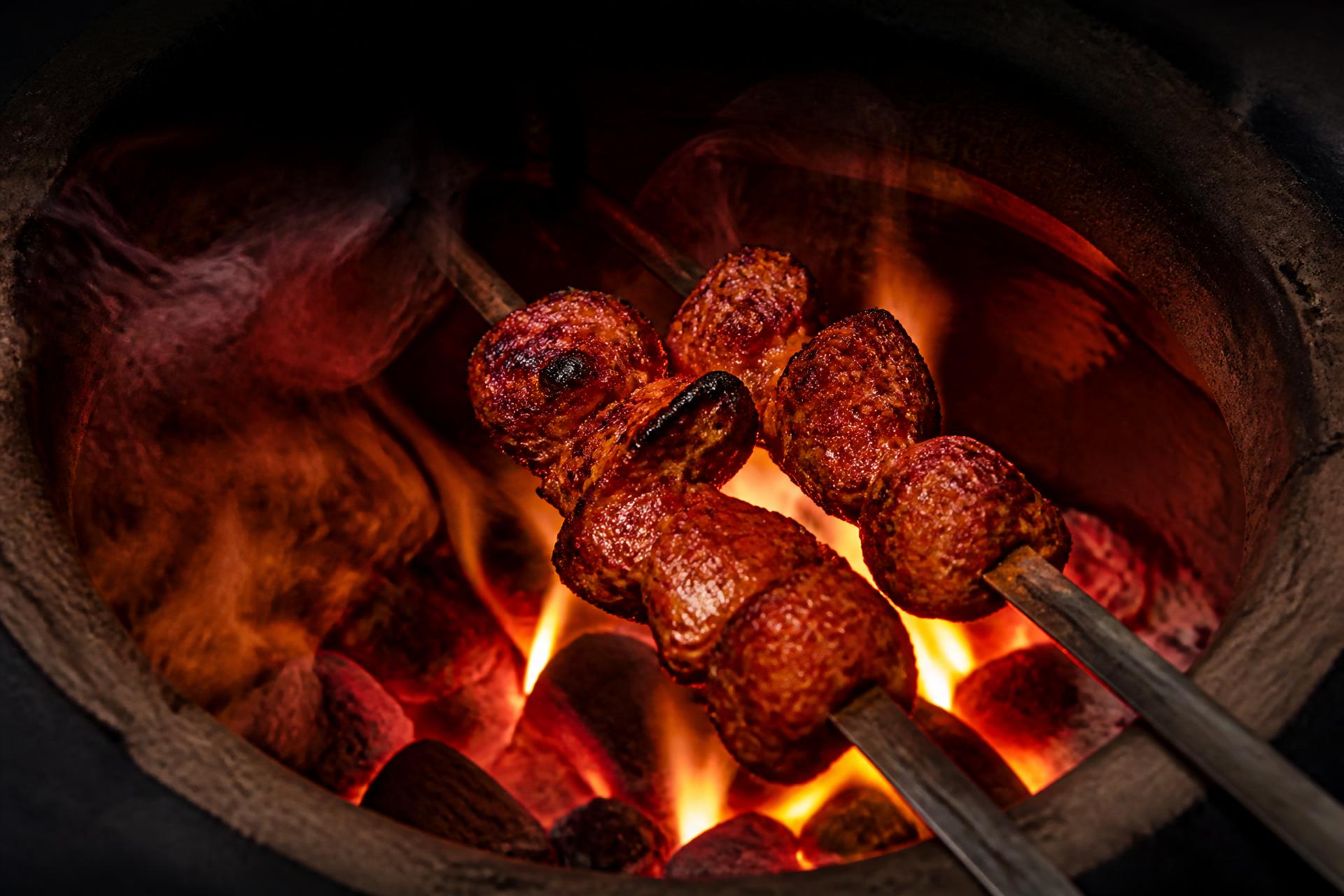 Sizzling tandoori kebabs over glowing charcoal